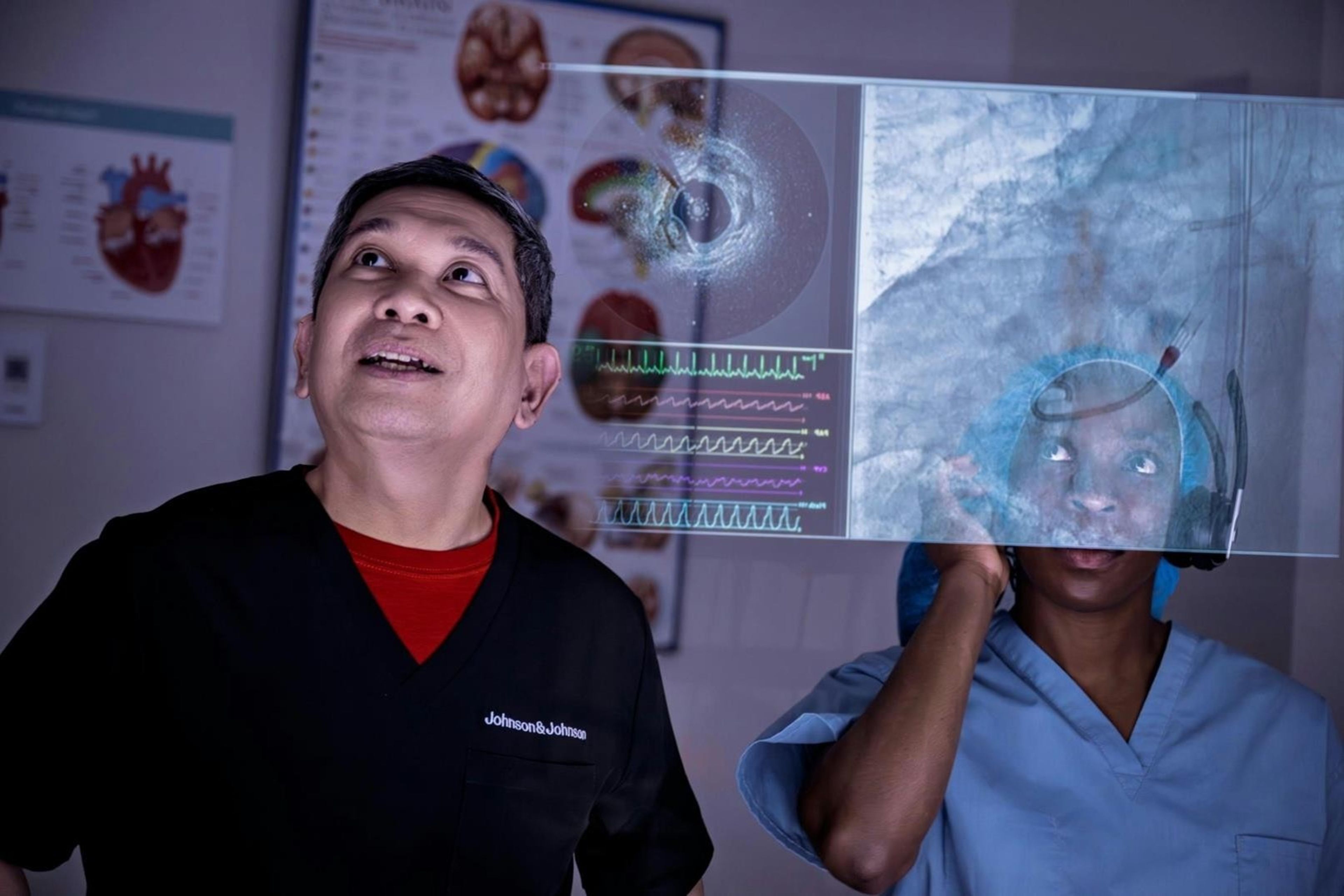 two medical professionals looking at a transparent screen