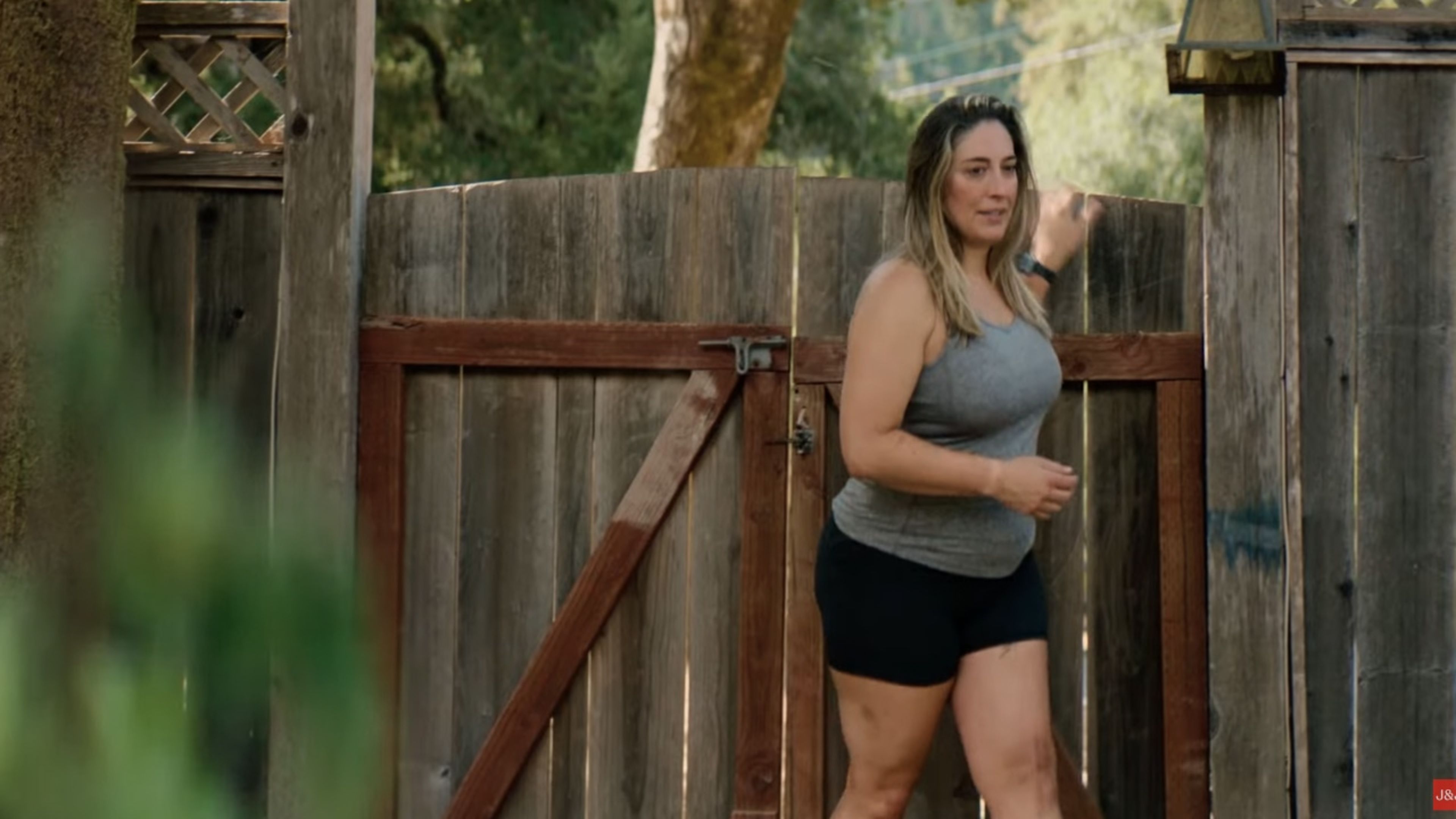 Woman walking through a gate outdoors