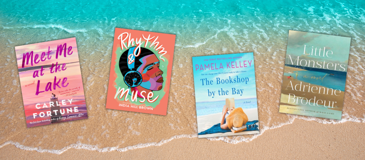 Waves and sand on the beach with an array of beach reads