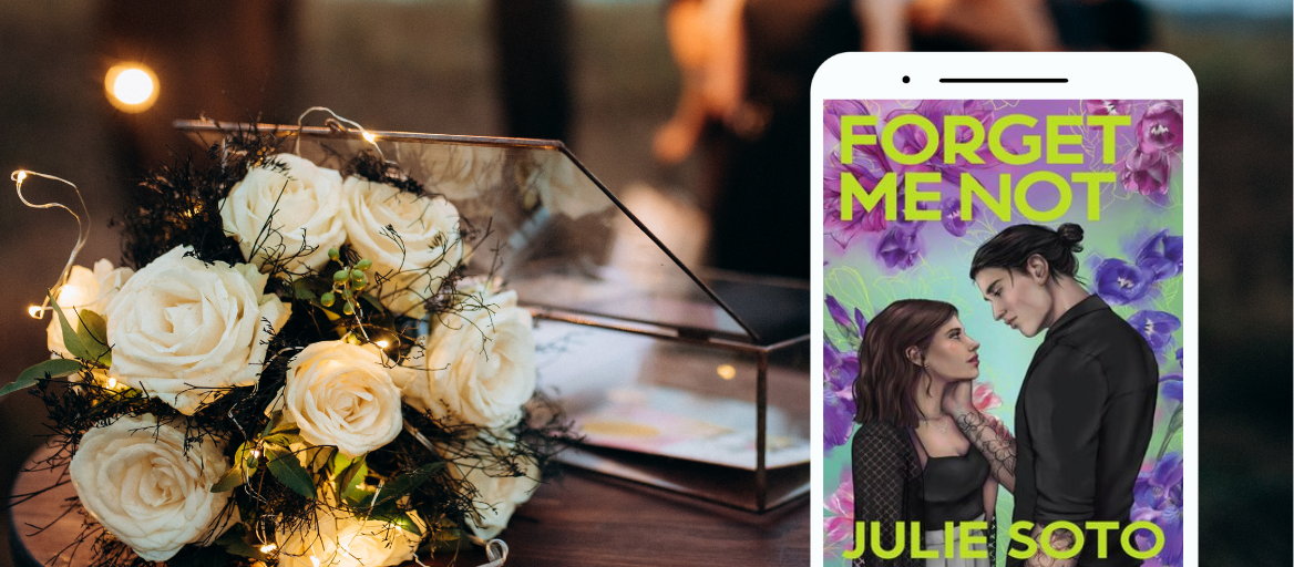 A bouquet of white roses and twinkle lights sit on a table. A tablet features the book "Forget Me Not."