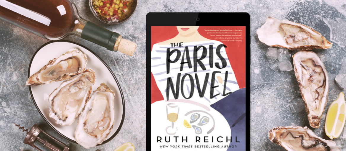 Table with oysters and wine and a tablet featuring "The Paris Novel"