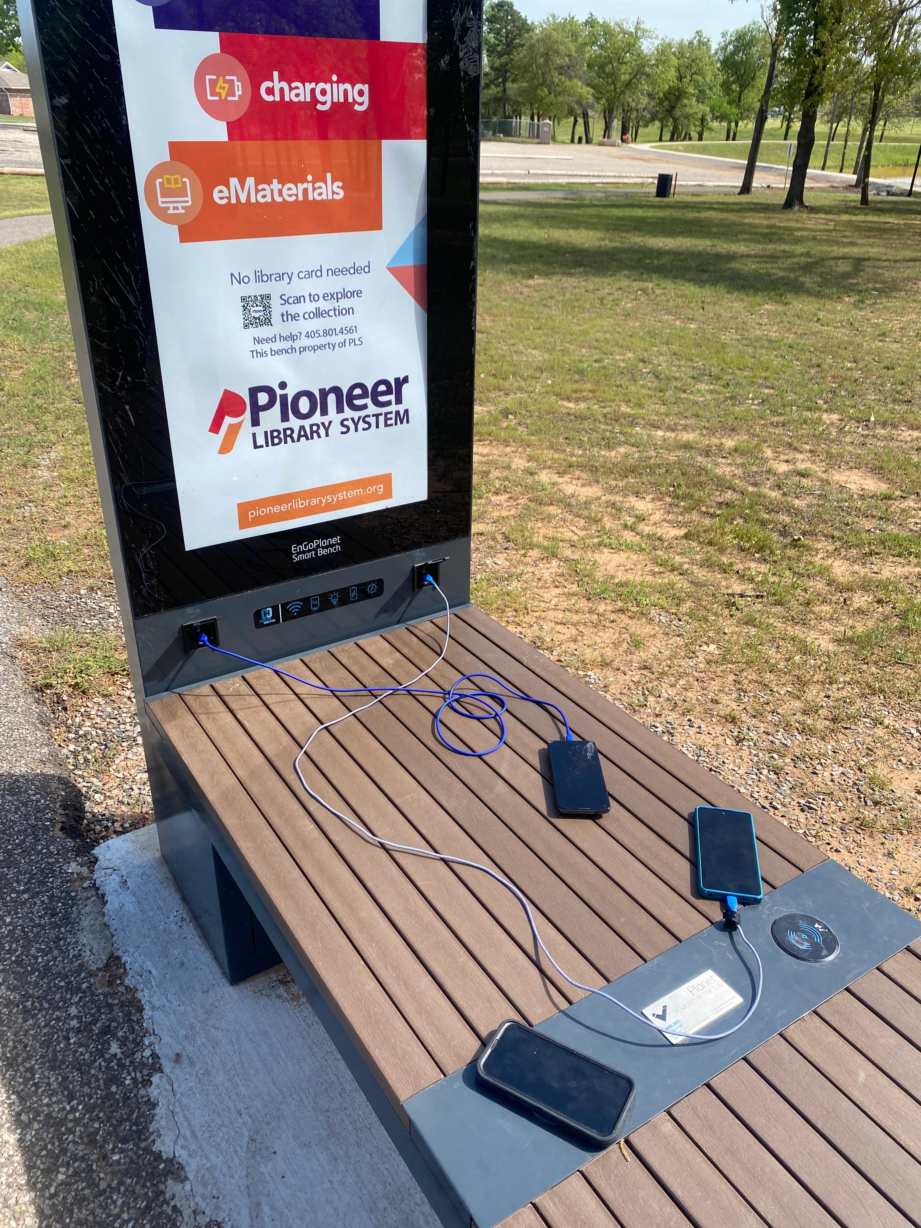 Devices charging at a bench at the Pioneer Library System