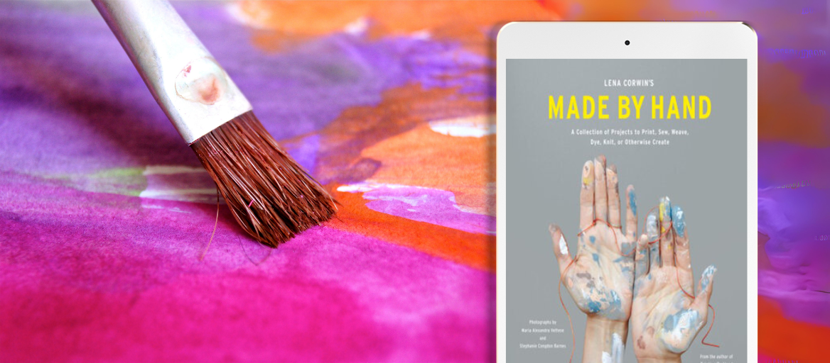 A paintbrush on a colorful canvas with phone featuring the ebook "Made by Hand."