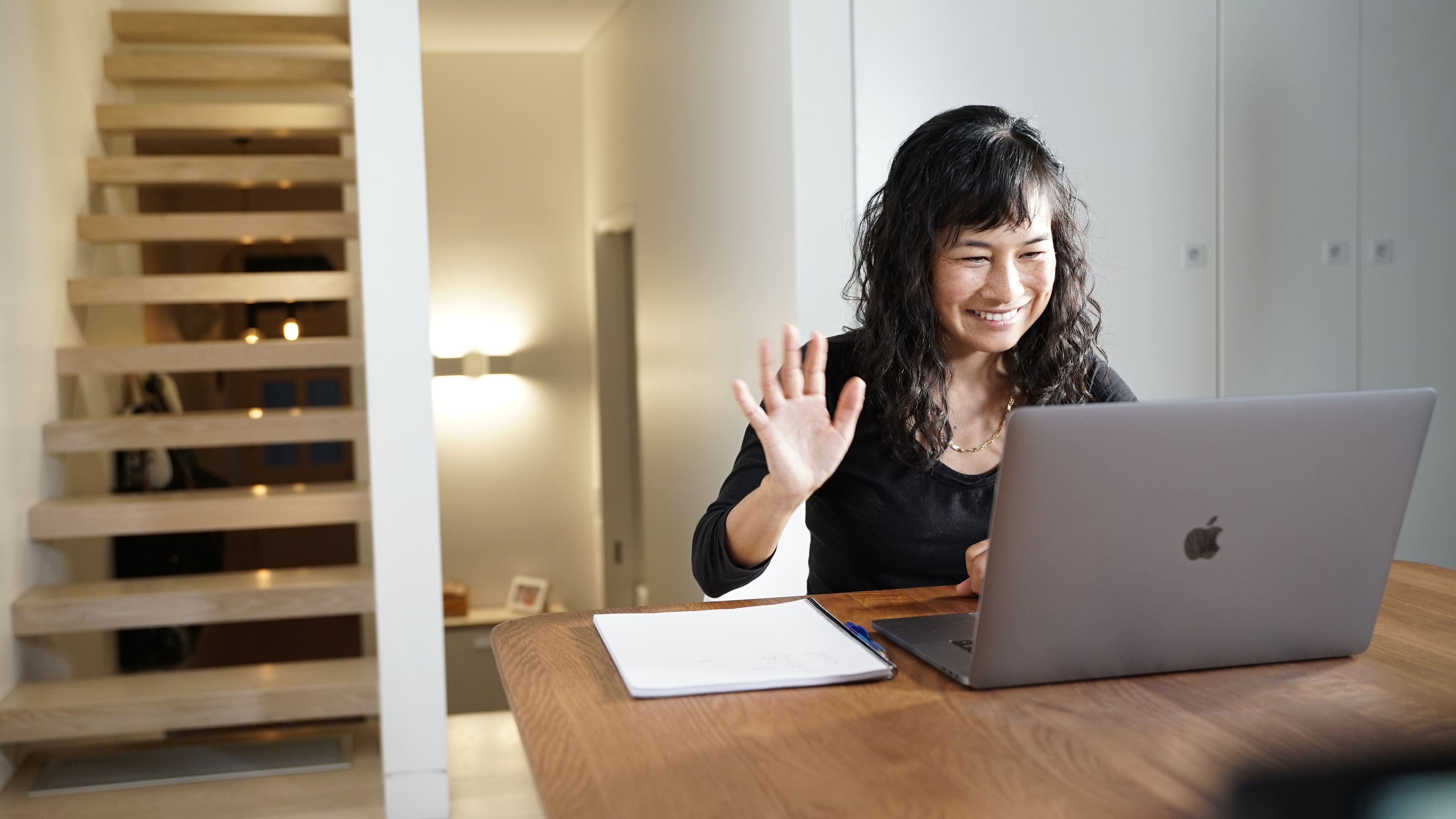 Woman in her house, attending an english class online.