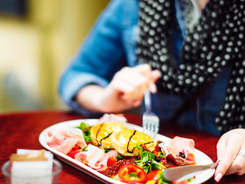 Woman eating an exotic dish.