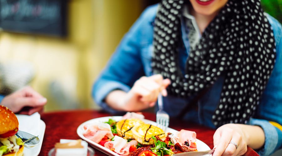 Woman eating an exotic dish.