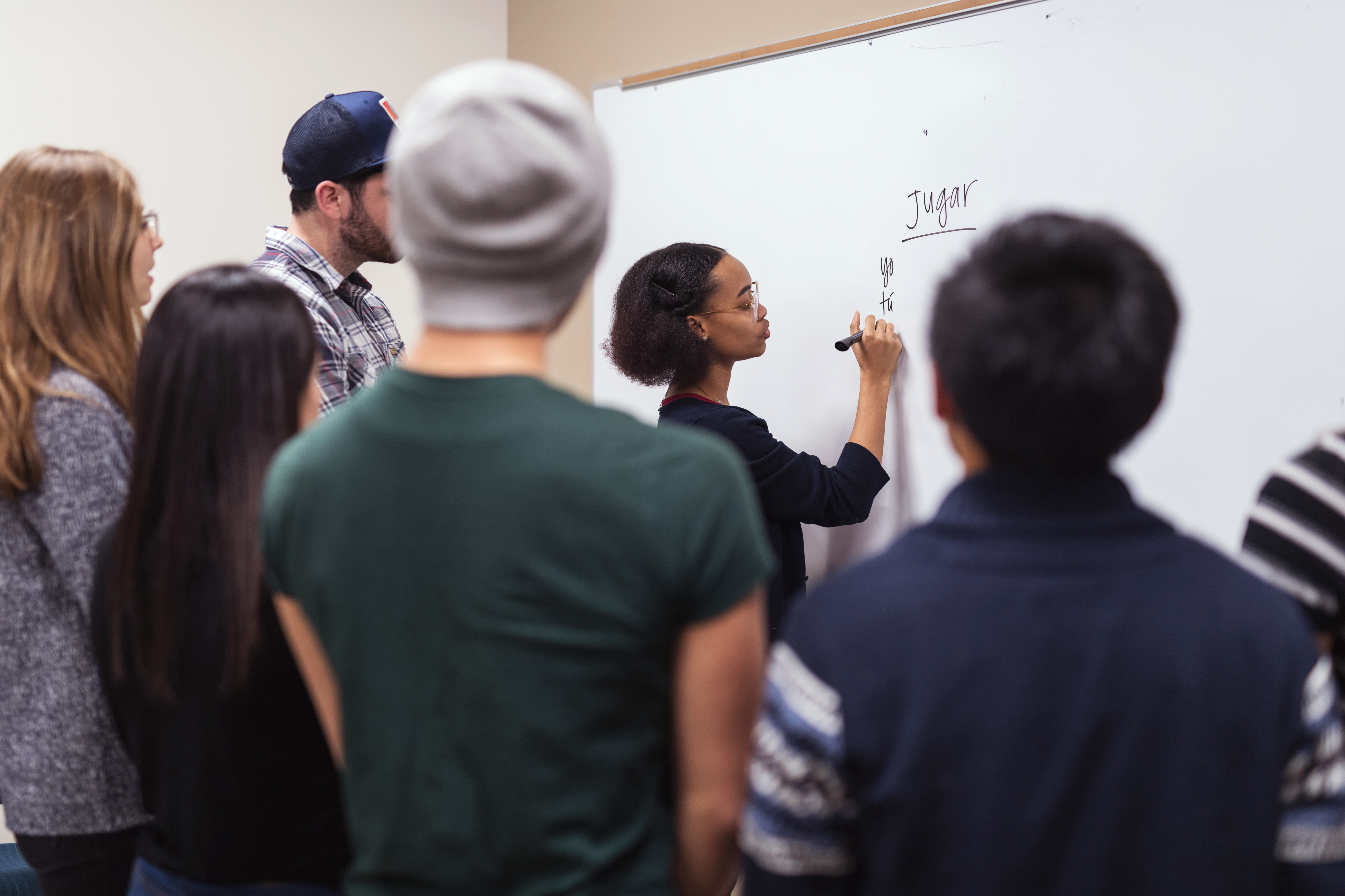 A group of students paying attention to their teacher teaching them a language.