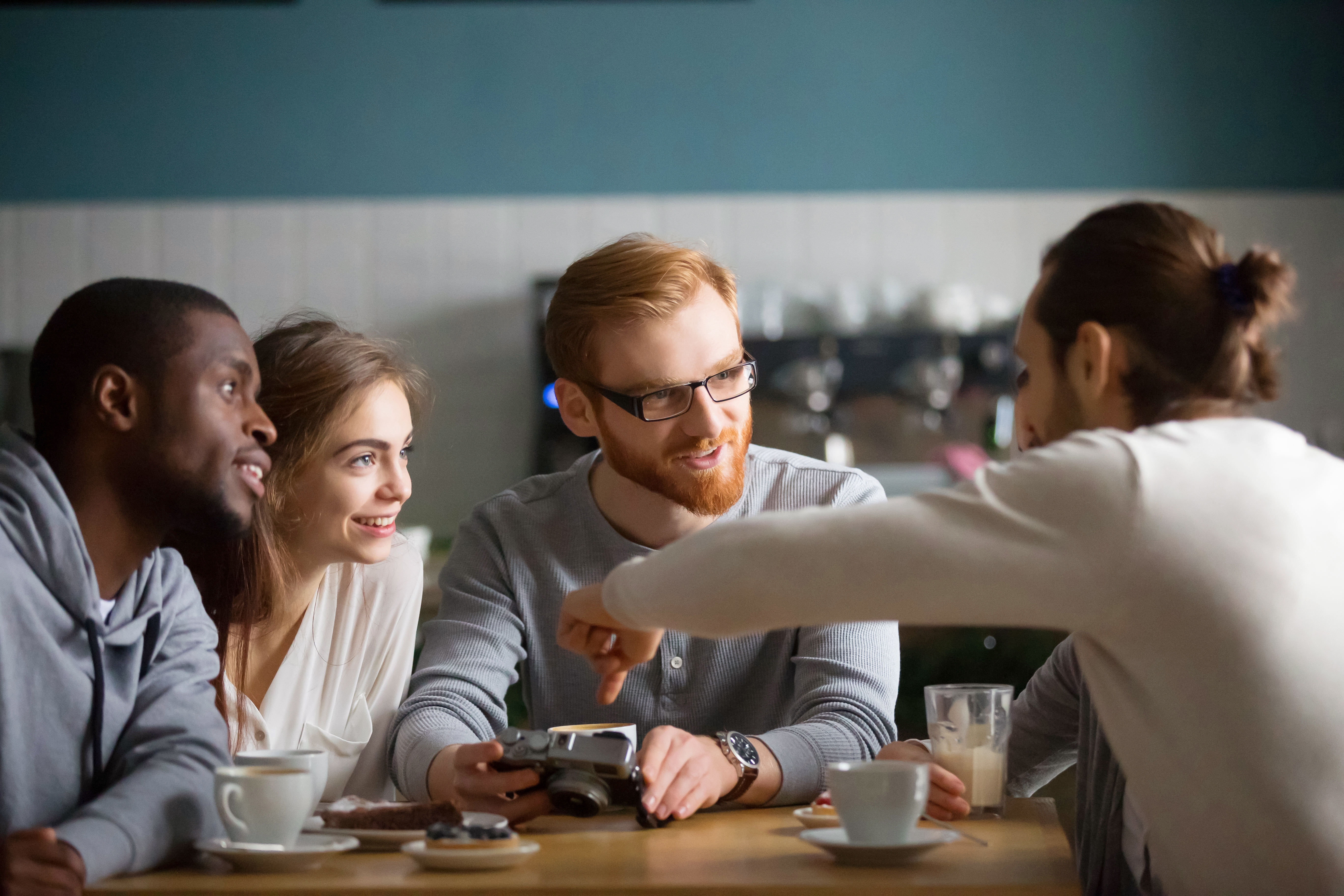 Group of friends talking in a cafe.