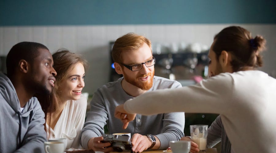 Group of friends talking in a cafe.