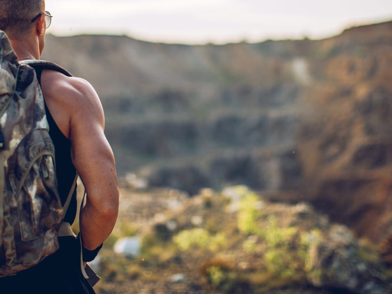 Man walking alone on a trail in the United States.