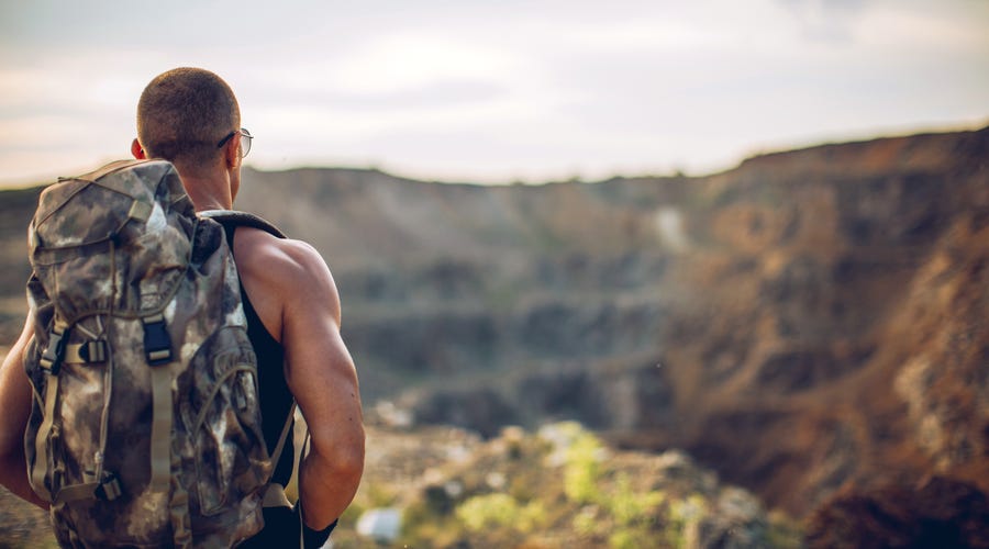 Man walking alone on a trail in the United States.