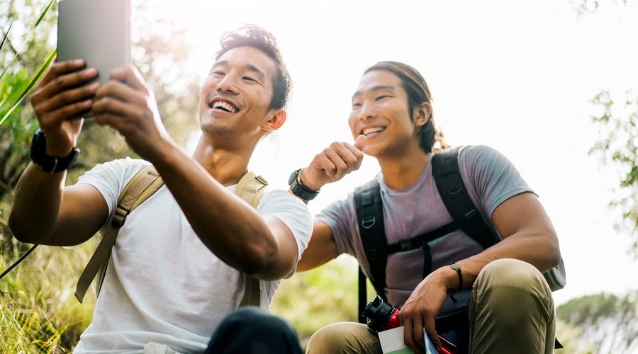 Two friends making a video call outdoors.