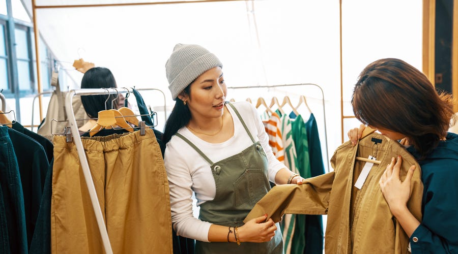 Two female friends looking at a clothing store