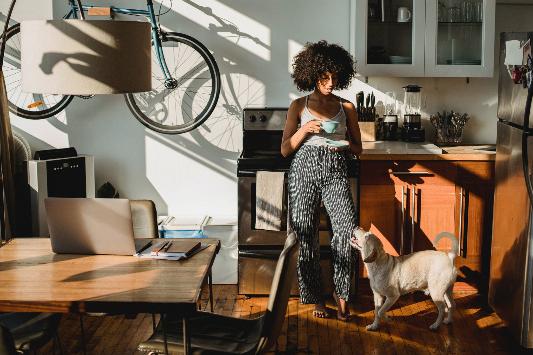 woman standing in kitchen with dog