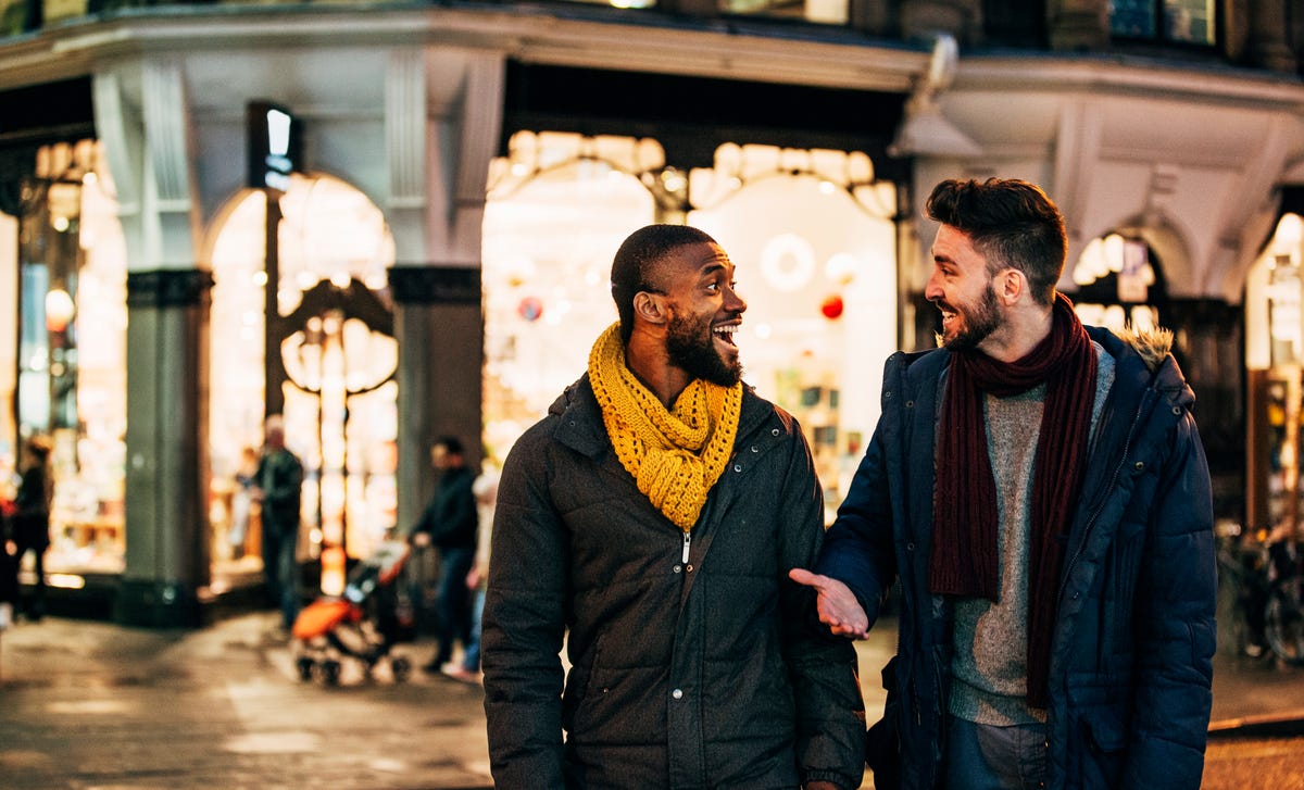 Two men walking on the street discussing Berlitz