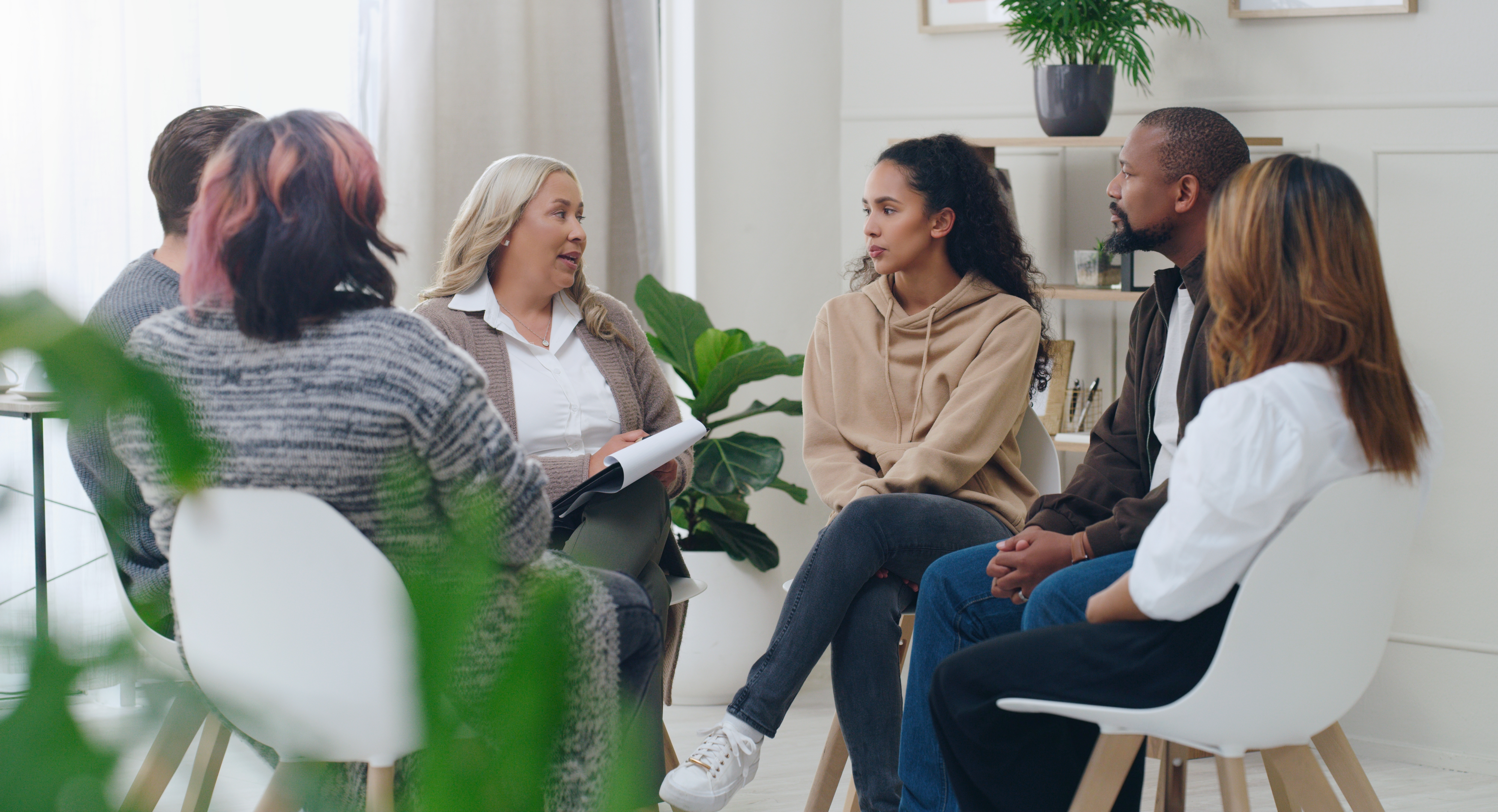 Group of students and their instructor sitting in a circle and learning a language with the Berlitz Method