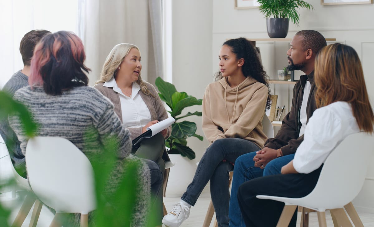 Group of students and their instructor sitting in a circle and learning a language with the Berlitz Method