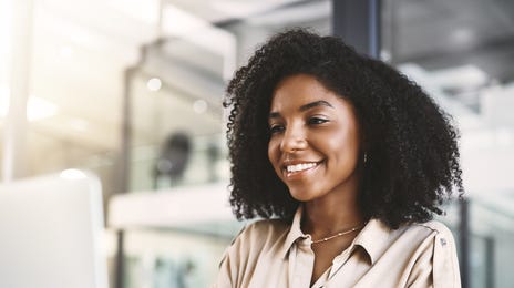 Woman in front of a laptop using Berlitz Connect to learn a language