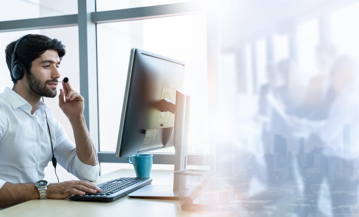Man sitting at his table at his workplace and attending an online business seminar from his computer