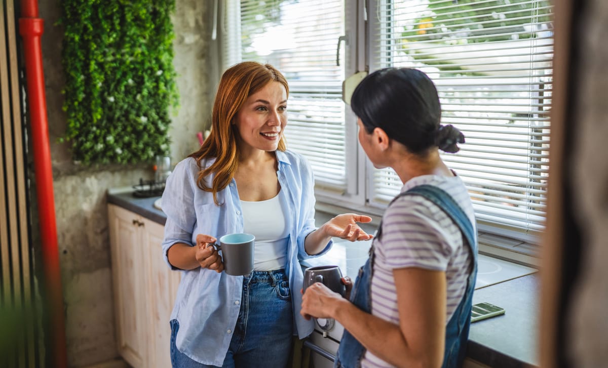 Two women sipping coffee and chatting in Hungarian after their Hungarian lesson with Berlitz