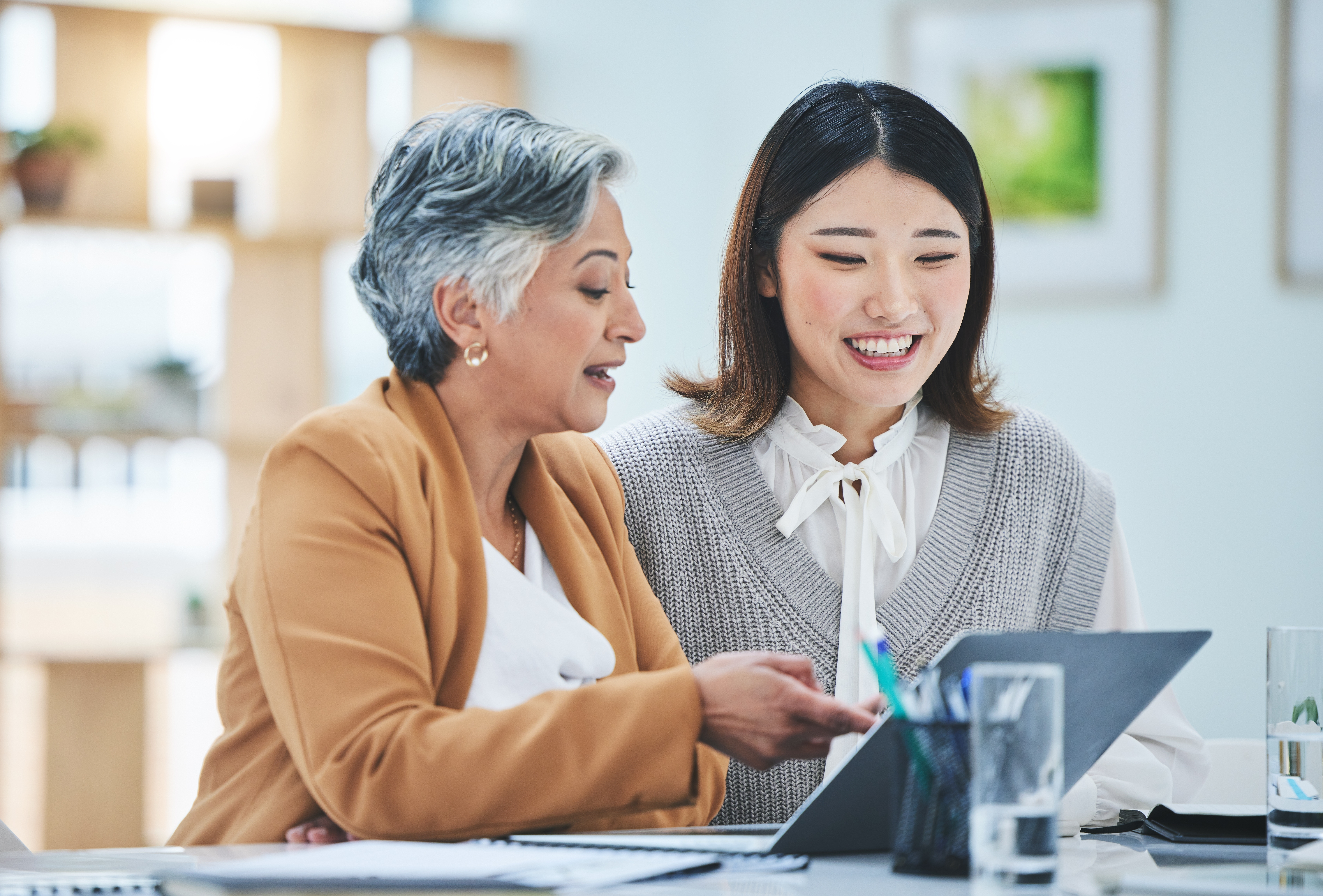 Elderly student improving her language skills and cultural knowledge with the help of her instructor during a private language lesson