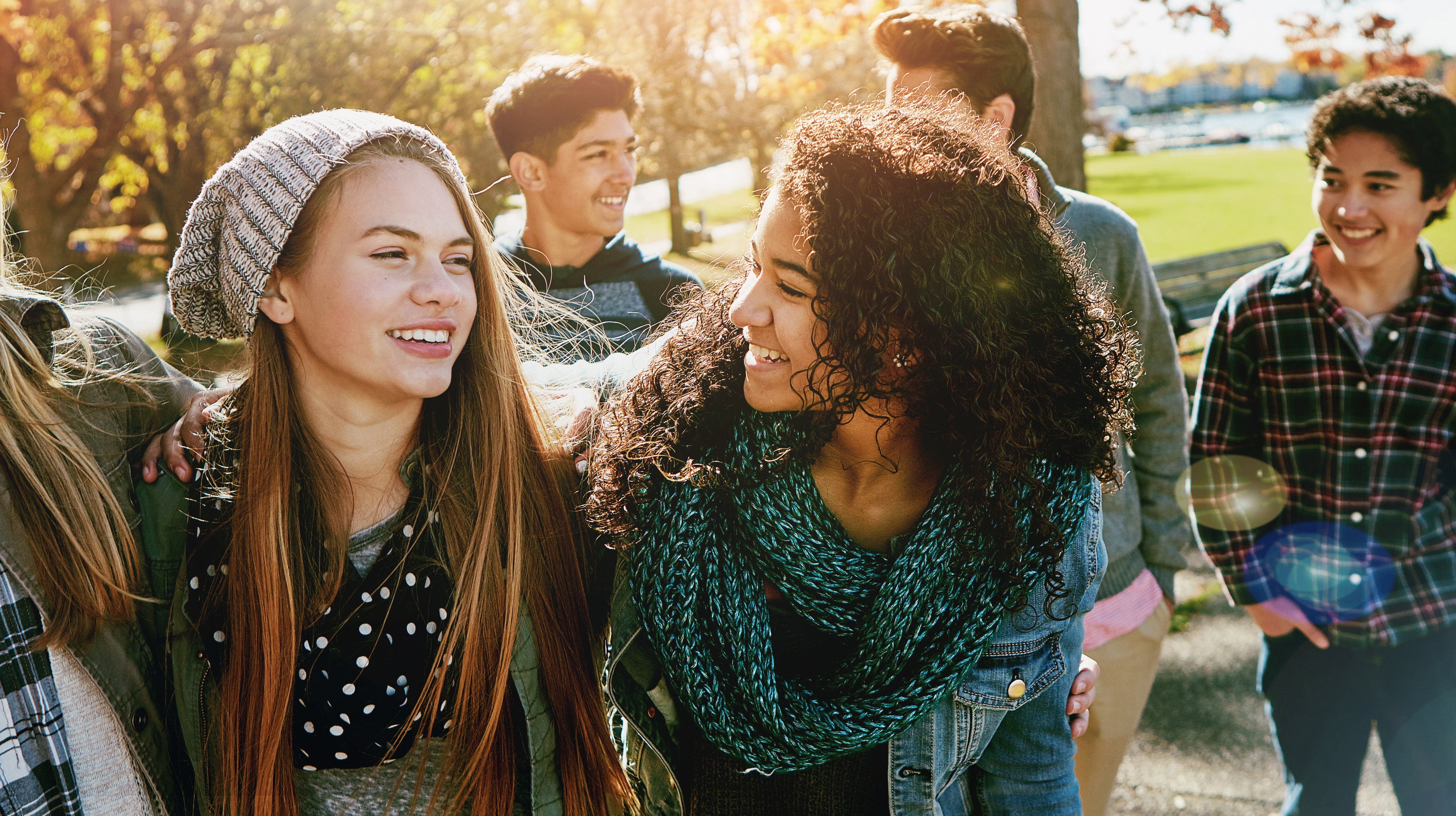 Teenagers talking to each other and smiling after they attended language courses for children with Berlitz