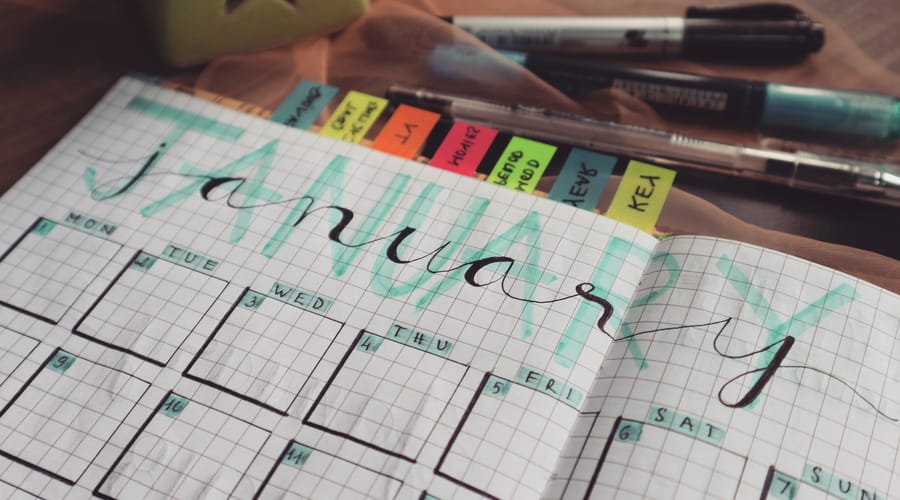 A decorated weekly planner with sticky notes showing the days of the week