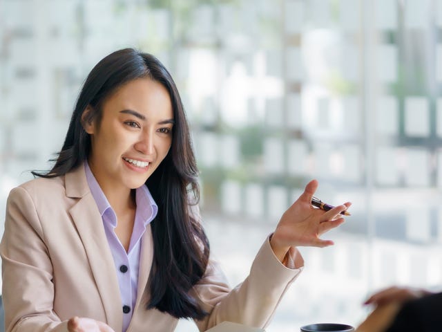 Woman talking to her coworker after she rescheduled a private language lesson to a time that fits her