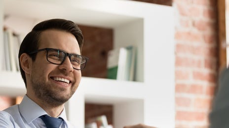 Man shaking hands with his interviewer after he applied for jobs at Berlitz