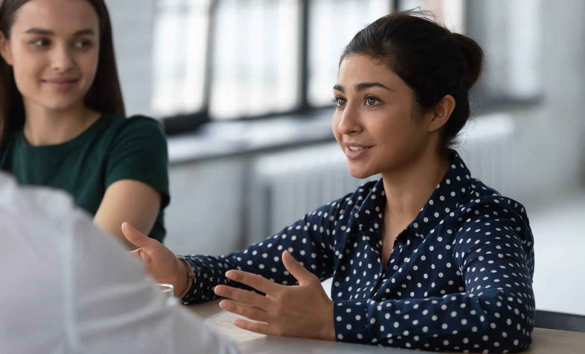 Woman taking French lessons and talking to her instructor using the Berlitz Method