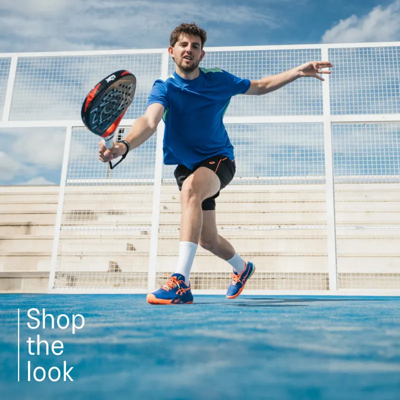 Athlete playing padel wearing padel shoes from ASICS on a blue court.