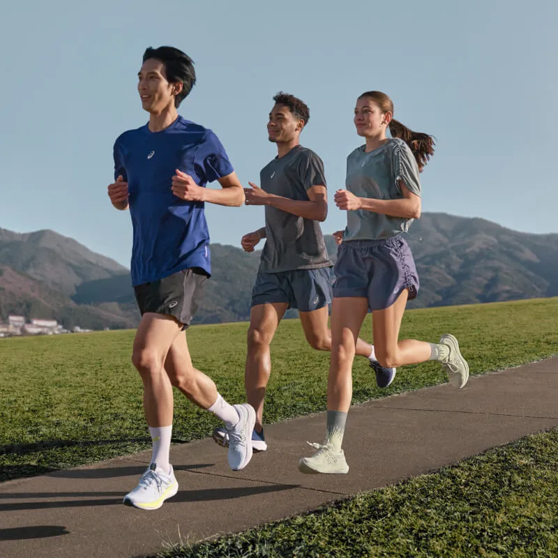 Three people running in GT-2000 14 running shoes on a road with nature in the background.
