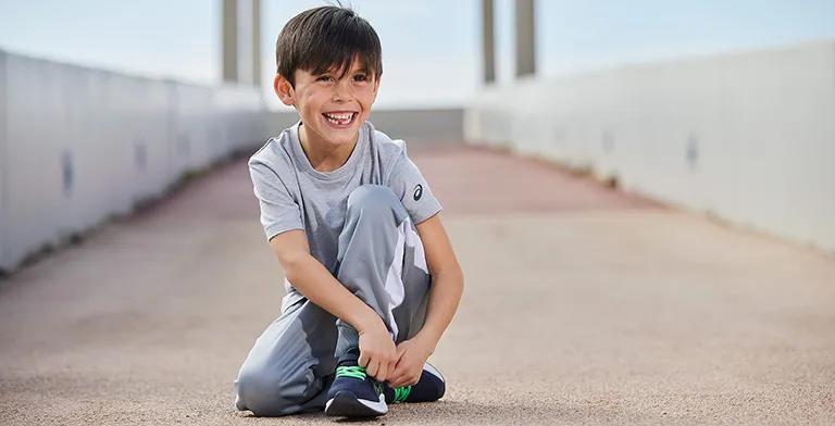 Young boy sitting and smiling