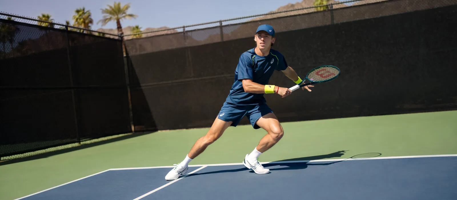 A tennis player outside playing on a tennis court