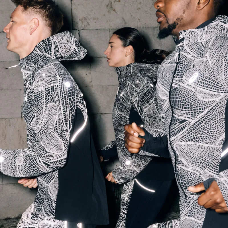 Limited series - close up of people running wearing reflective ASICS jackets
