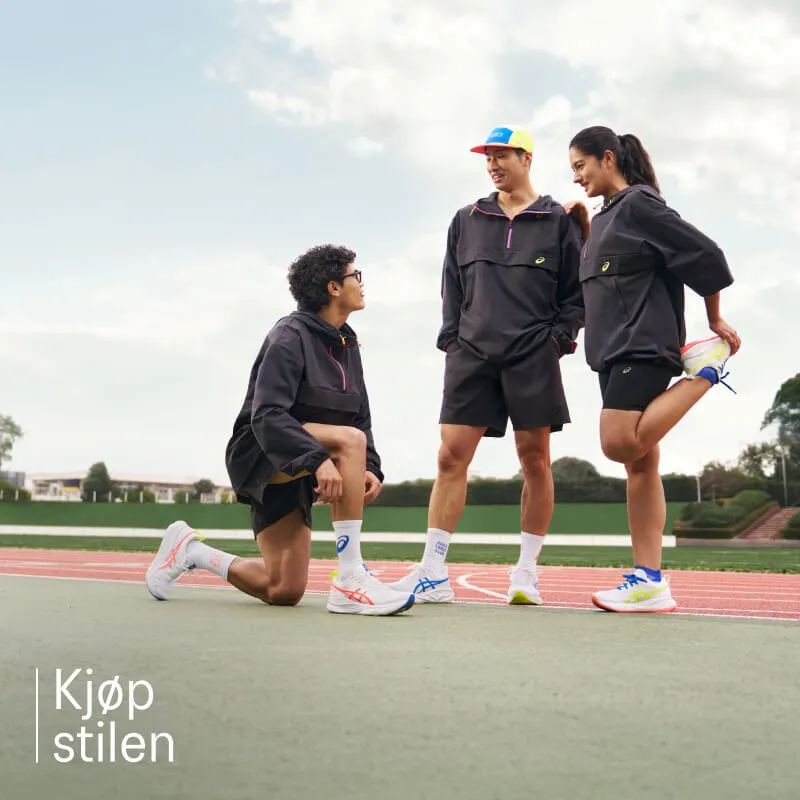 Runners standing on the field with ASICS TRACK CLUB gear
