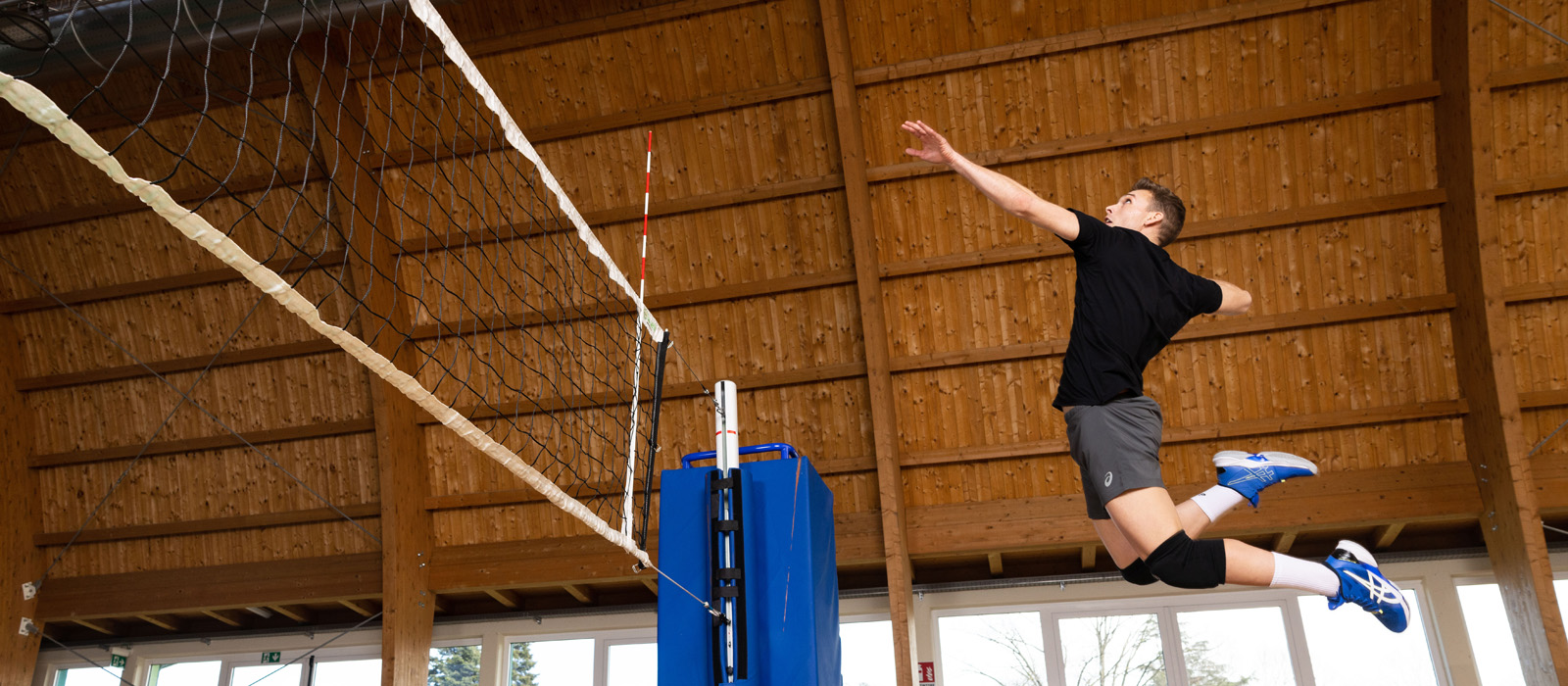 Man is jumping to reach the volleyball