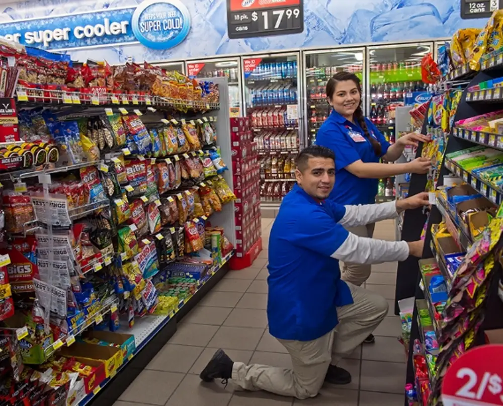 Two store employees smiling together 