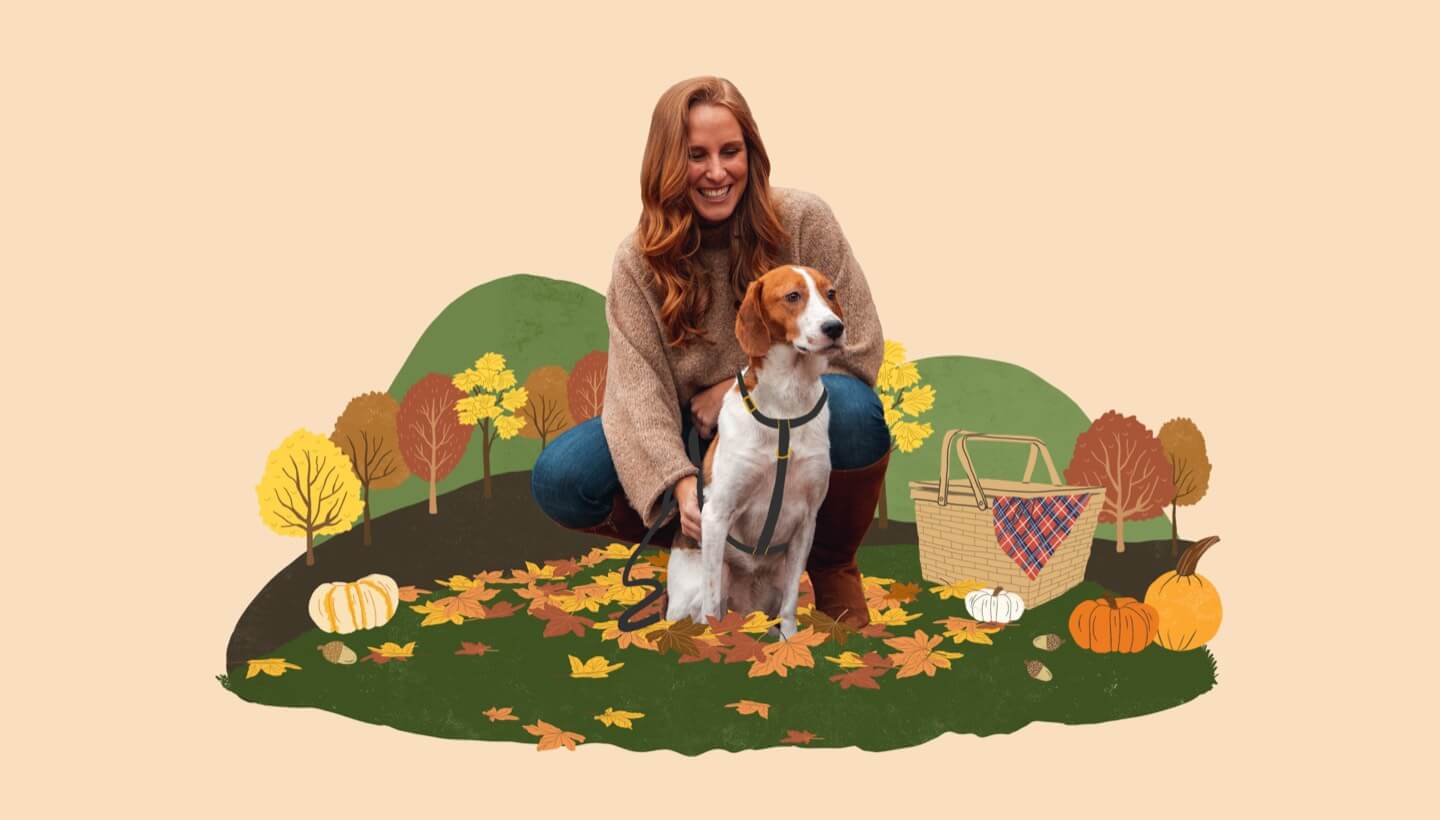 Woman sitting with dog on grass