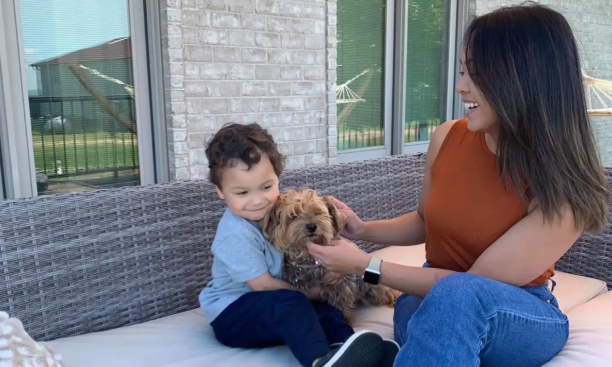 Mother and son sitting with their dog.