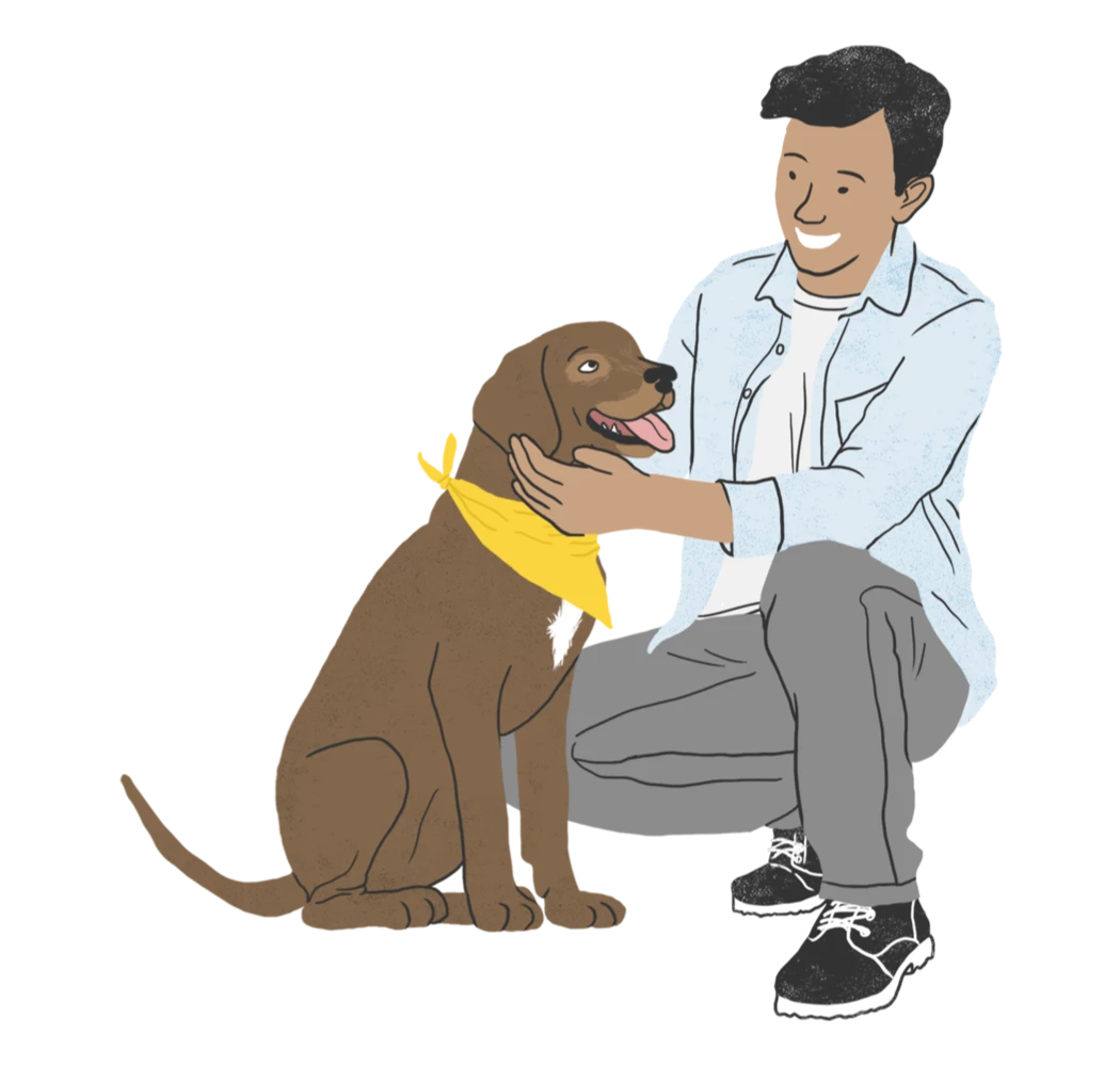 A man kneeling down next to a brown dog.