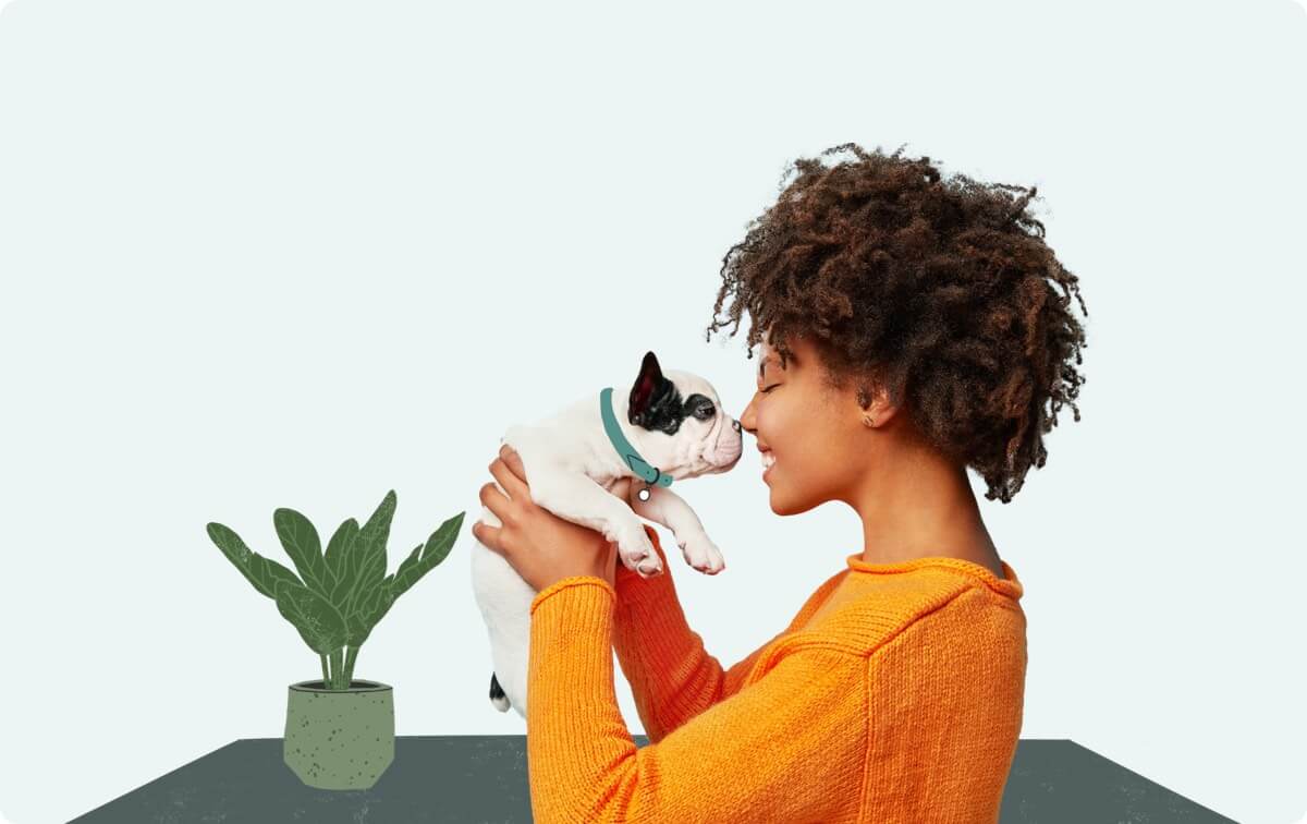 A woman holding a small white and black dog.