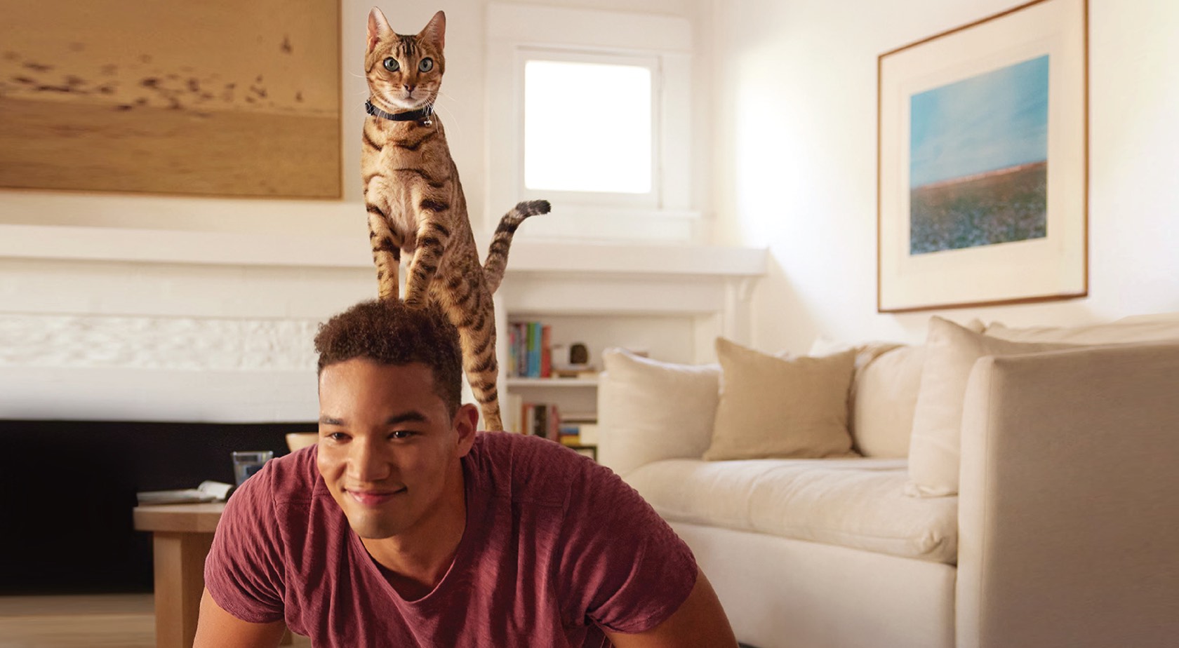 man with cat standing on back