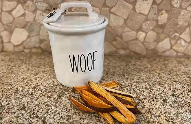 A white ceramic container and treats on top of a counter.