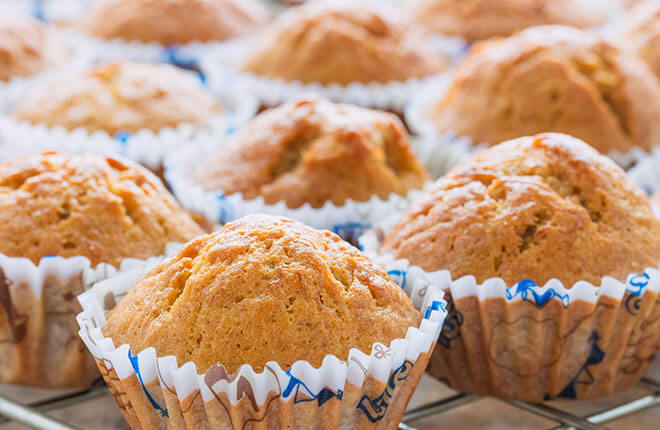 A close up of muffins on a cooling rack.