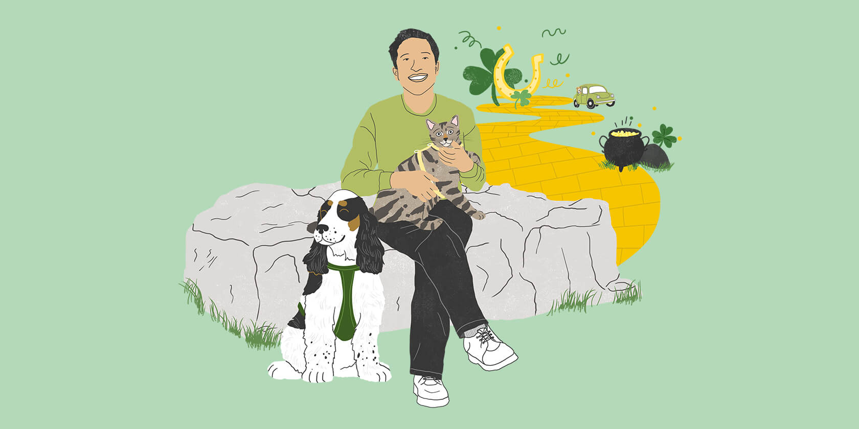 Man with cat and dog sitting on a rock