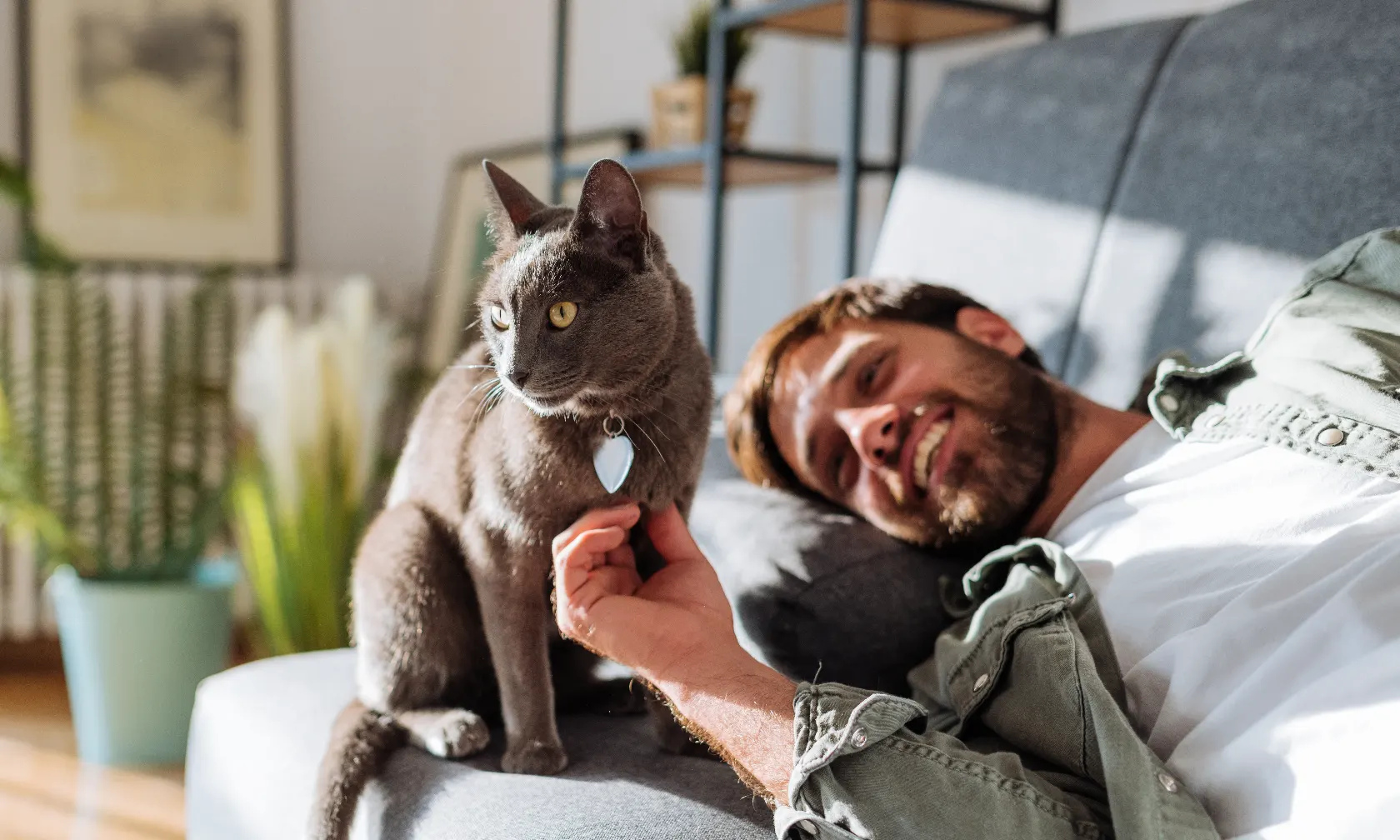 A man laying in bed with a cat.