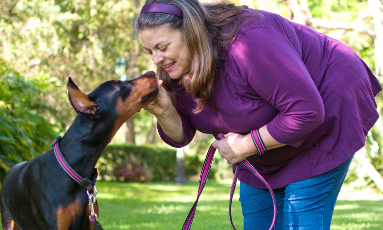 Woman giving her dog praise