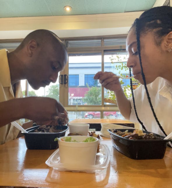 My partner and I are enjoying our meal at Simone’s, Black-woman-owned Caribbean Restaurant in New York. 