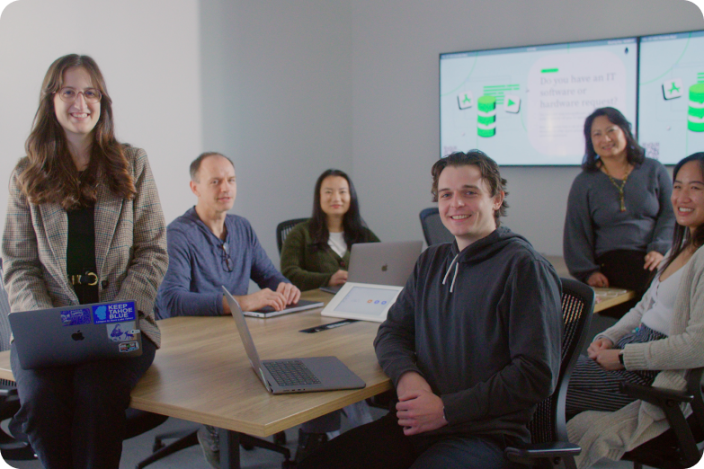 MongoDB Employees sitting at a conference table smiling